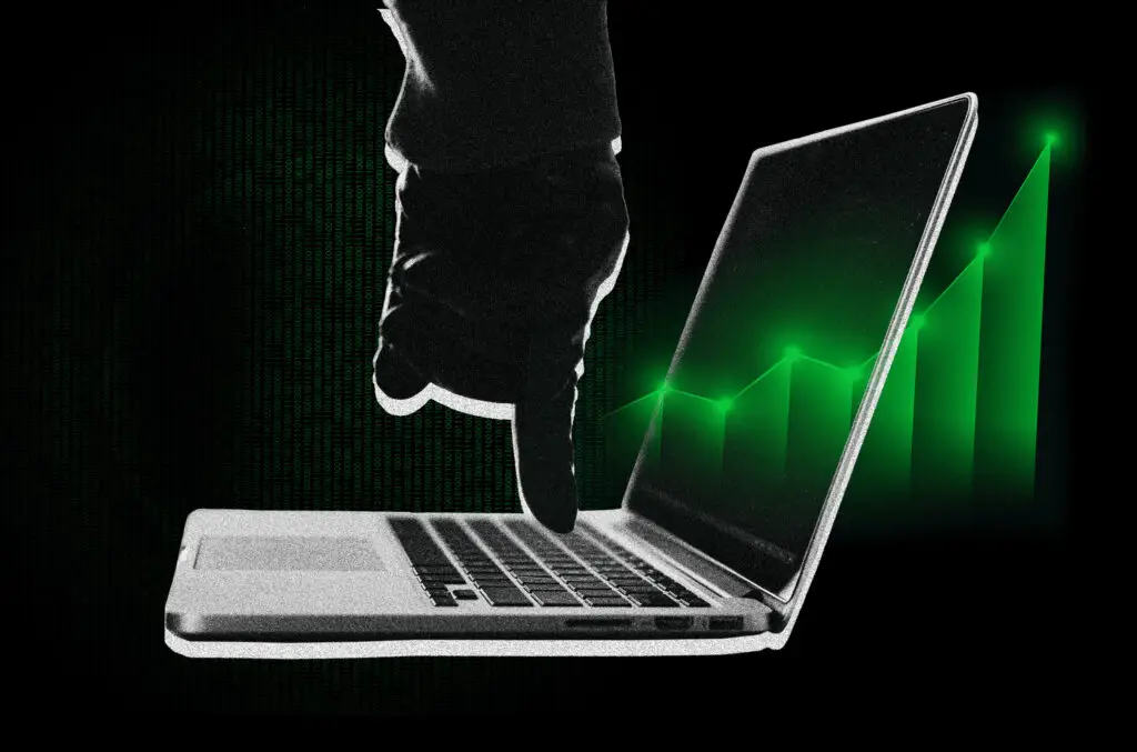 Finger pressing a button on a laptop, illustrating cybersecurity threat monitoring.
